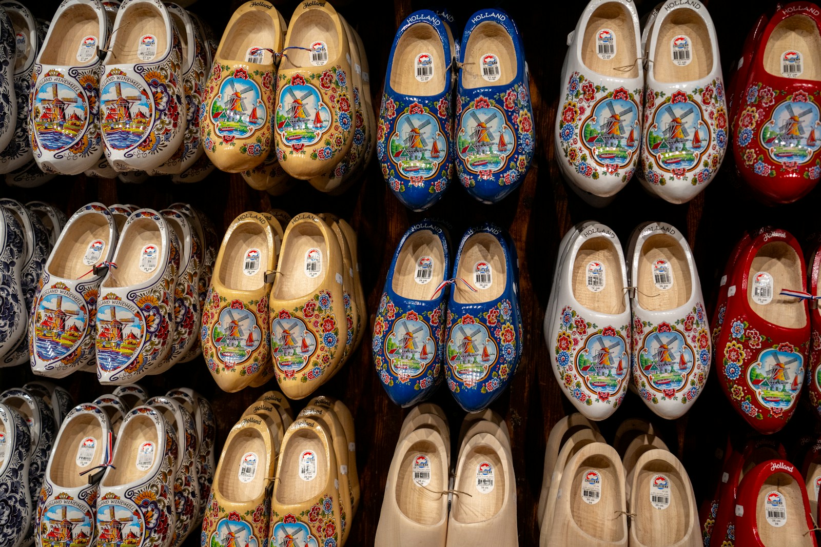 Rows of colorful hand painted wooden clogs