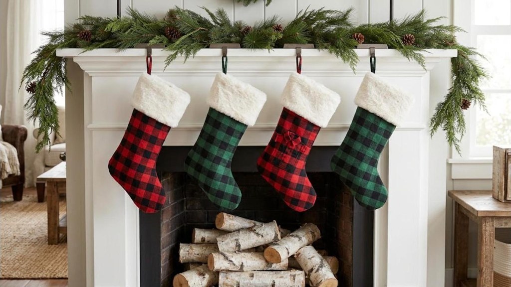 Red and green buffalo check flannel stockings with ivory faux fur cuffs on a white mantel