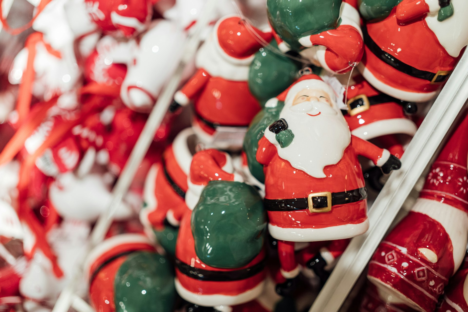 Christmas blow molds style Santa figures piled together at a market