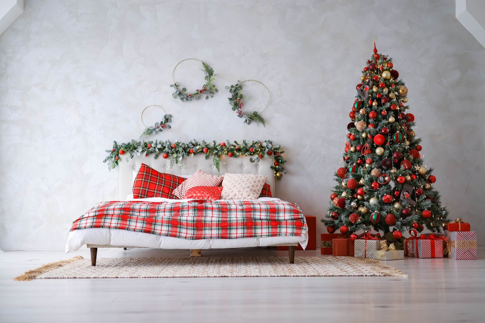 Guest room plaid Christmas decor with red plaid bedding and a decorated tree