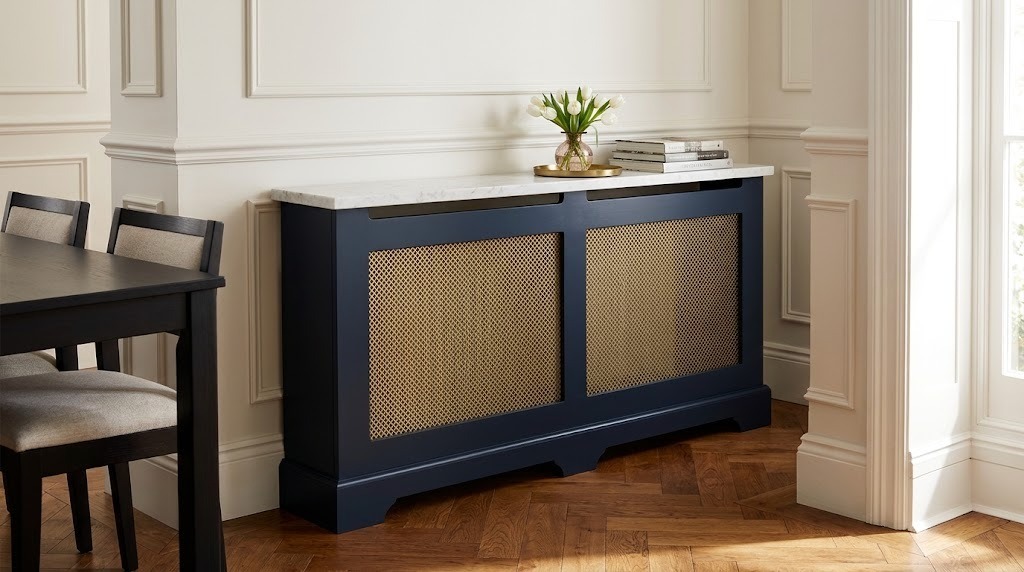 Radiator cover ideas: a navy cabinet with brass mesh panels and a marble top in a dining room