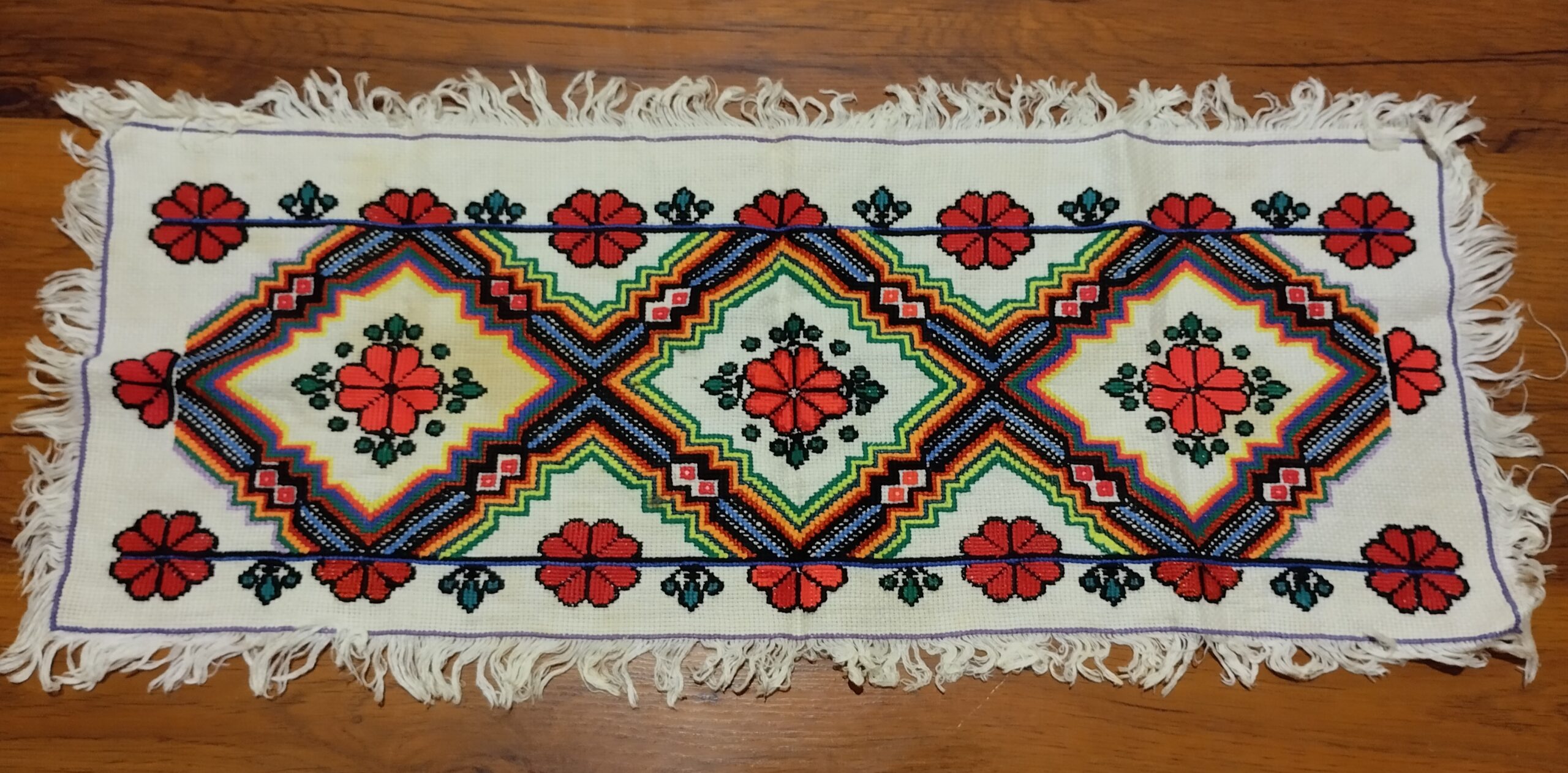 Christmas crafts for adults inspiration: red and black cross stitch embroidery on white linen