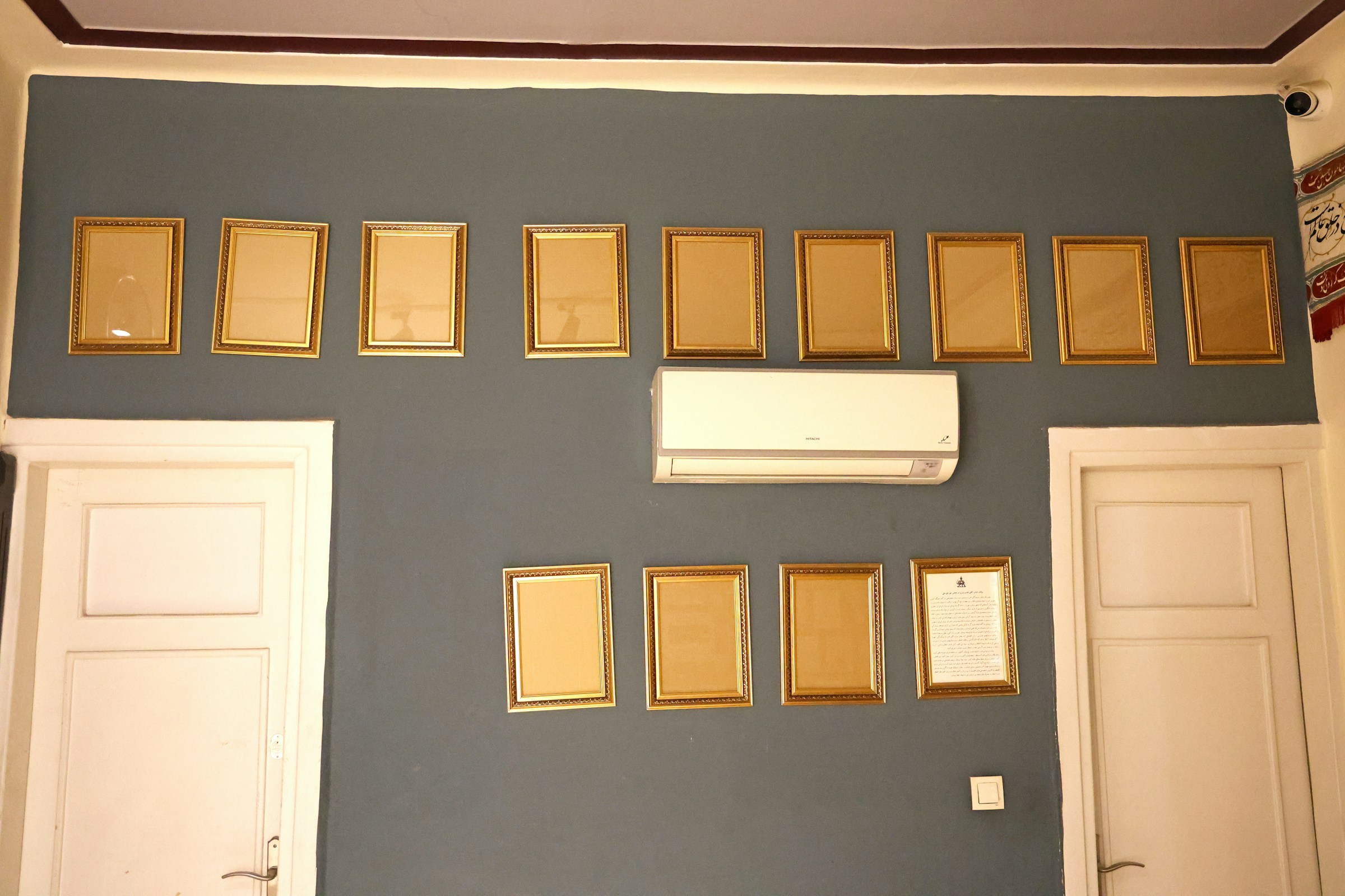 Renter friendly upgrades: gallery wall of gold picture frames arranged on a grey wall