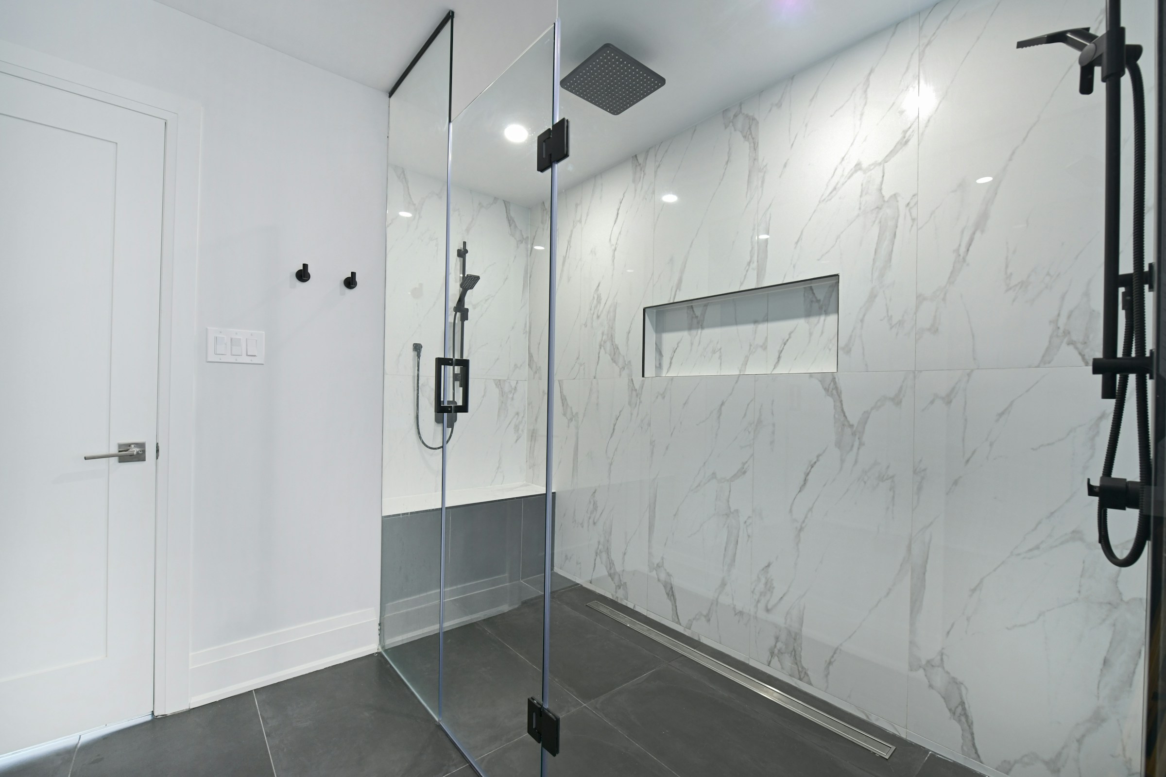 Modern bathroom with a glass enclosed shower and a rain shower head