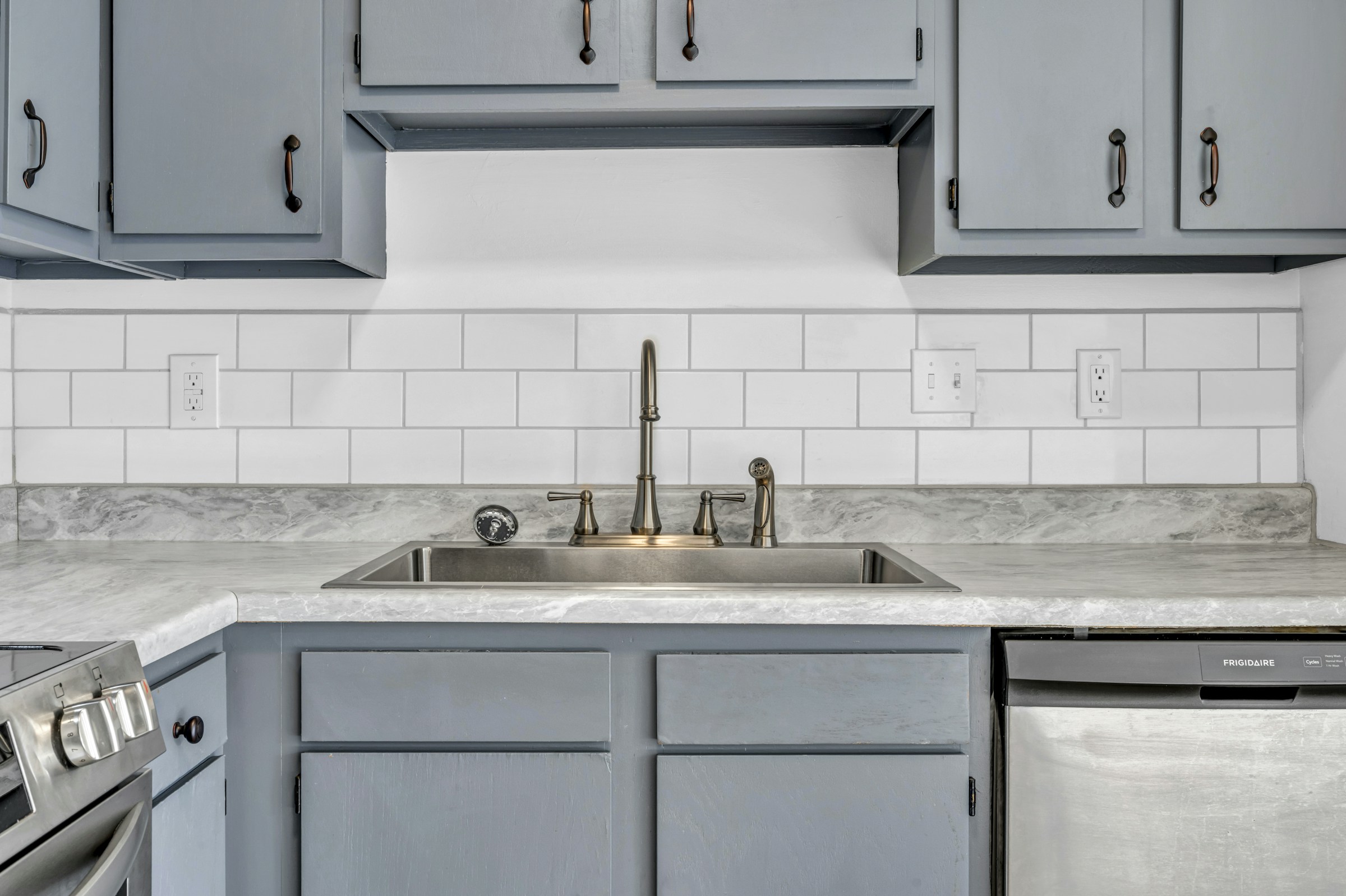 Kitchen sink with a white subway tile backsplash