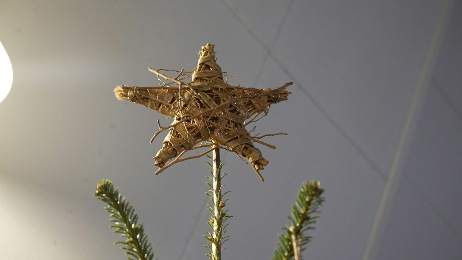 Rustic natural twig star on top of a Christmas tree