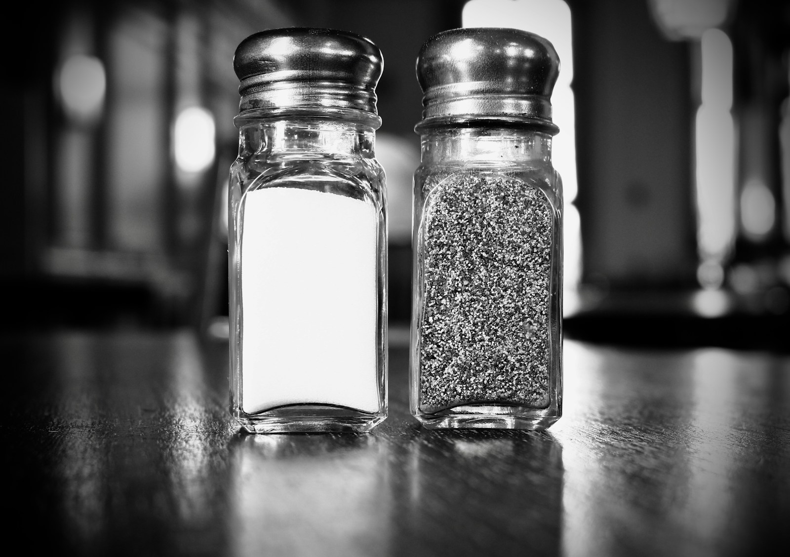 Pair of glass salt and pepper shakers on a table