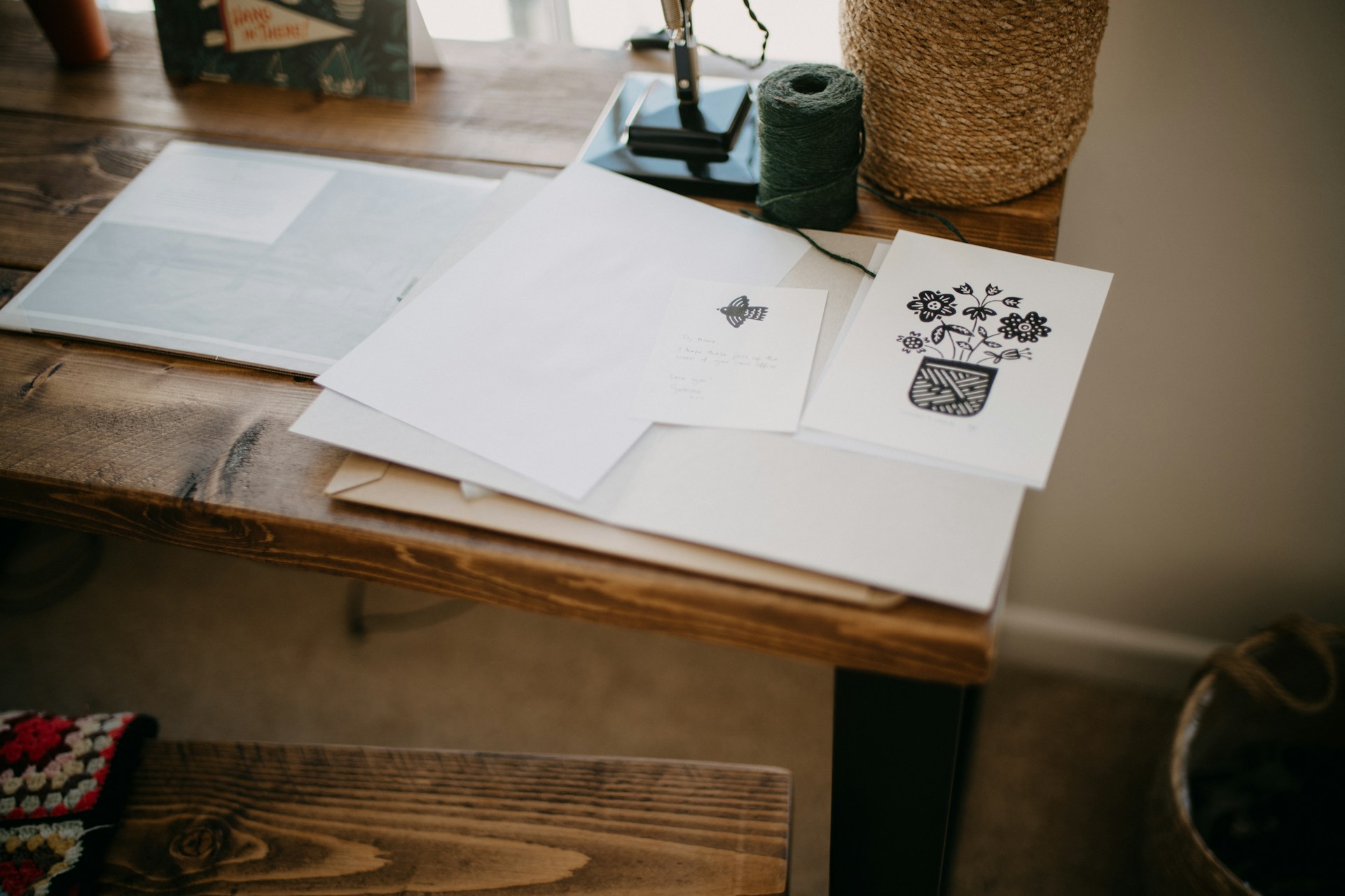 Handwritten letters and papers spread on a wooden desk