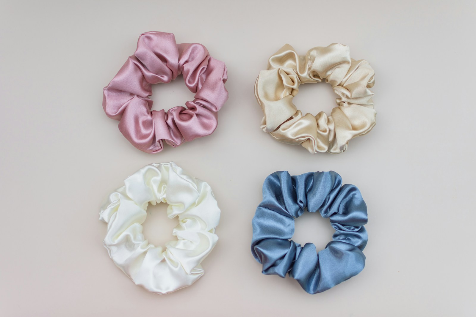 Sewing projects to sell: four satin scrunchies in pink, cream, white and blue