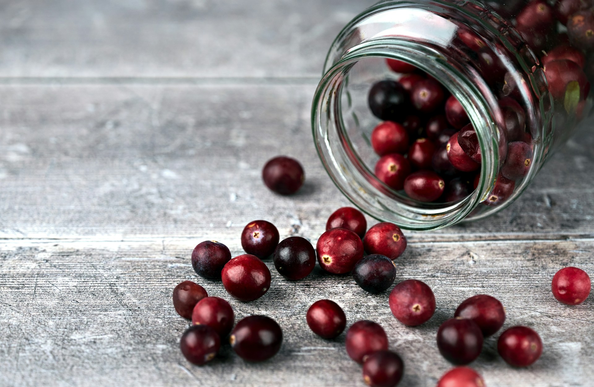 Fresh cranberries in a clear glass jar