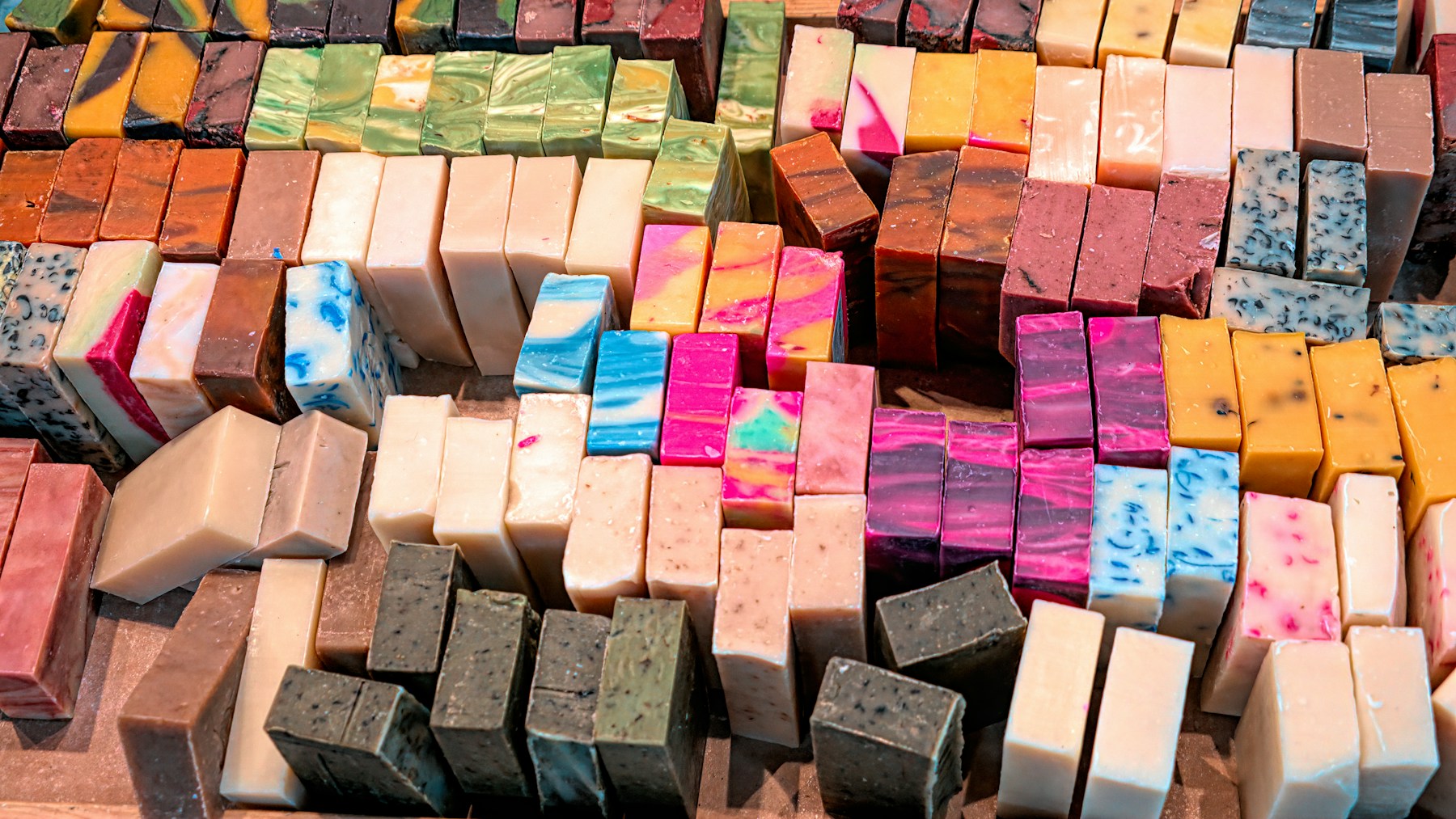 DIY Christmas soap craft fair display with colorful bars stacked in rows