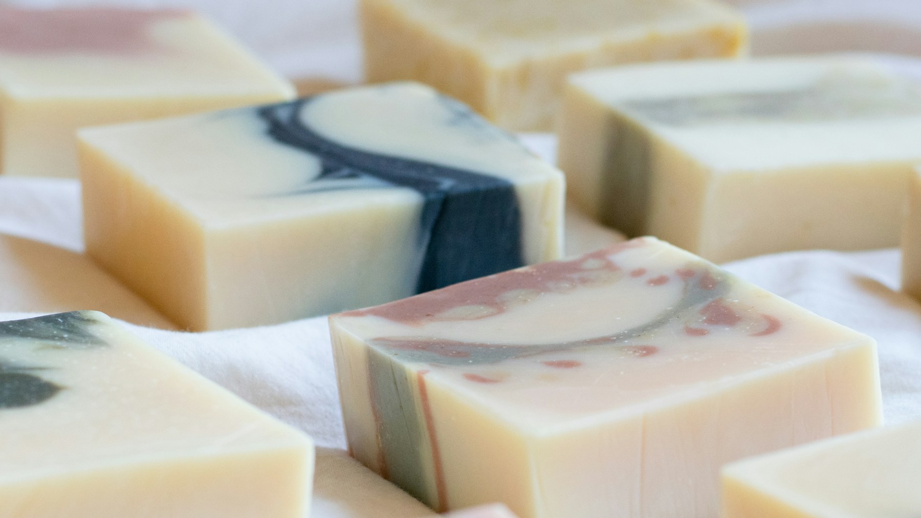 Creamy handmade soap bars with soft gray and blue swirls like winter snow