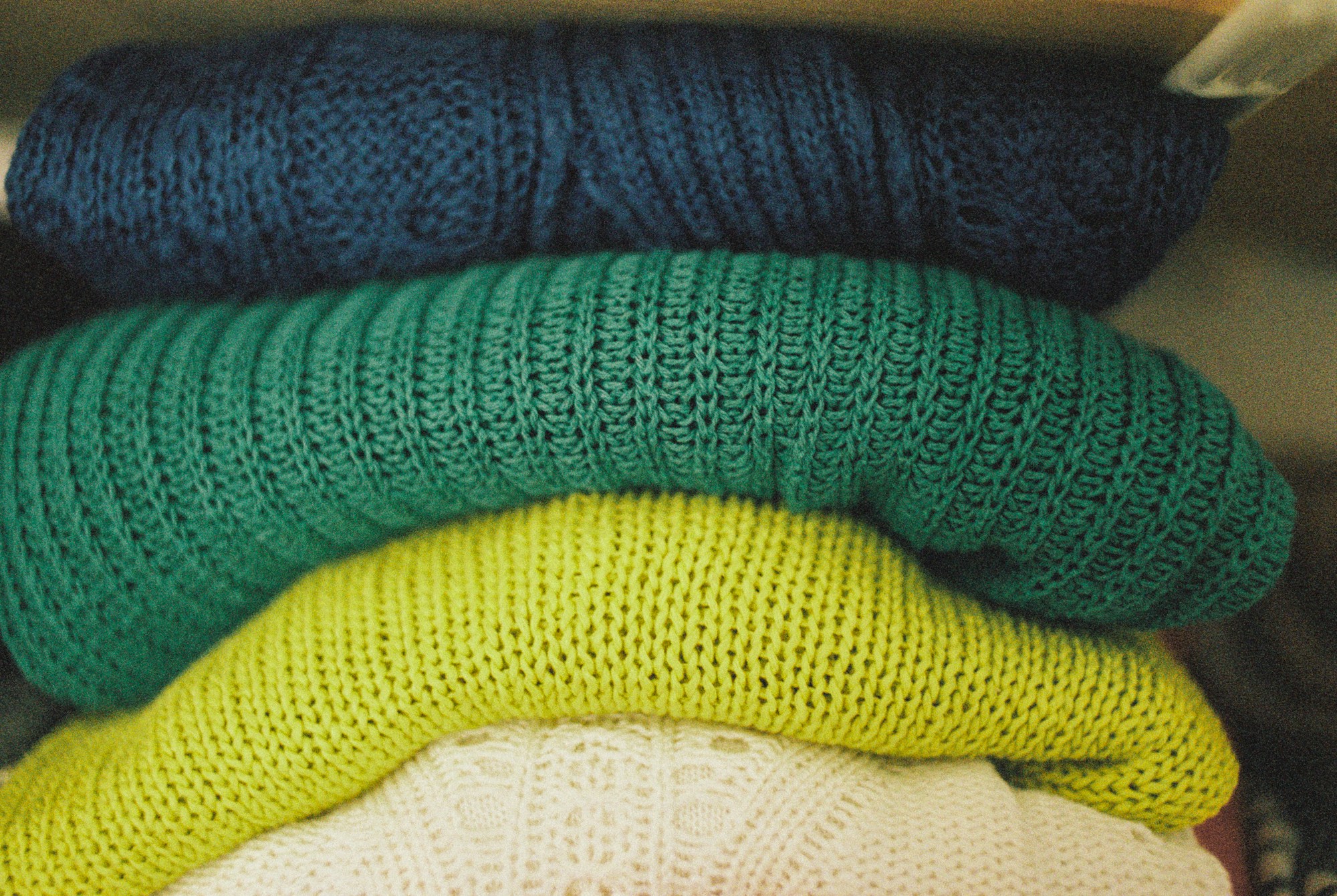 Brilliant organizing ideas: knit sweaters folded and stacked neatly on a shelf