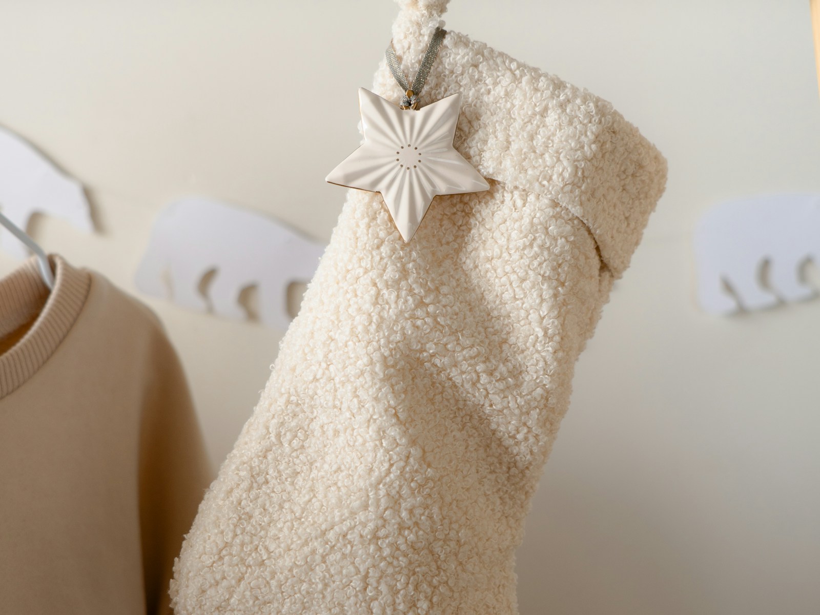 Cream linen farmhouse style stocking hanging from a wooden rod