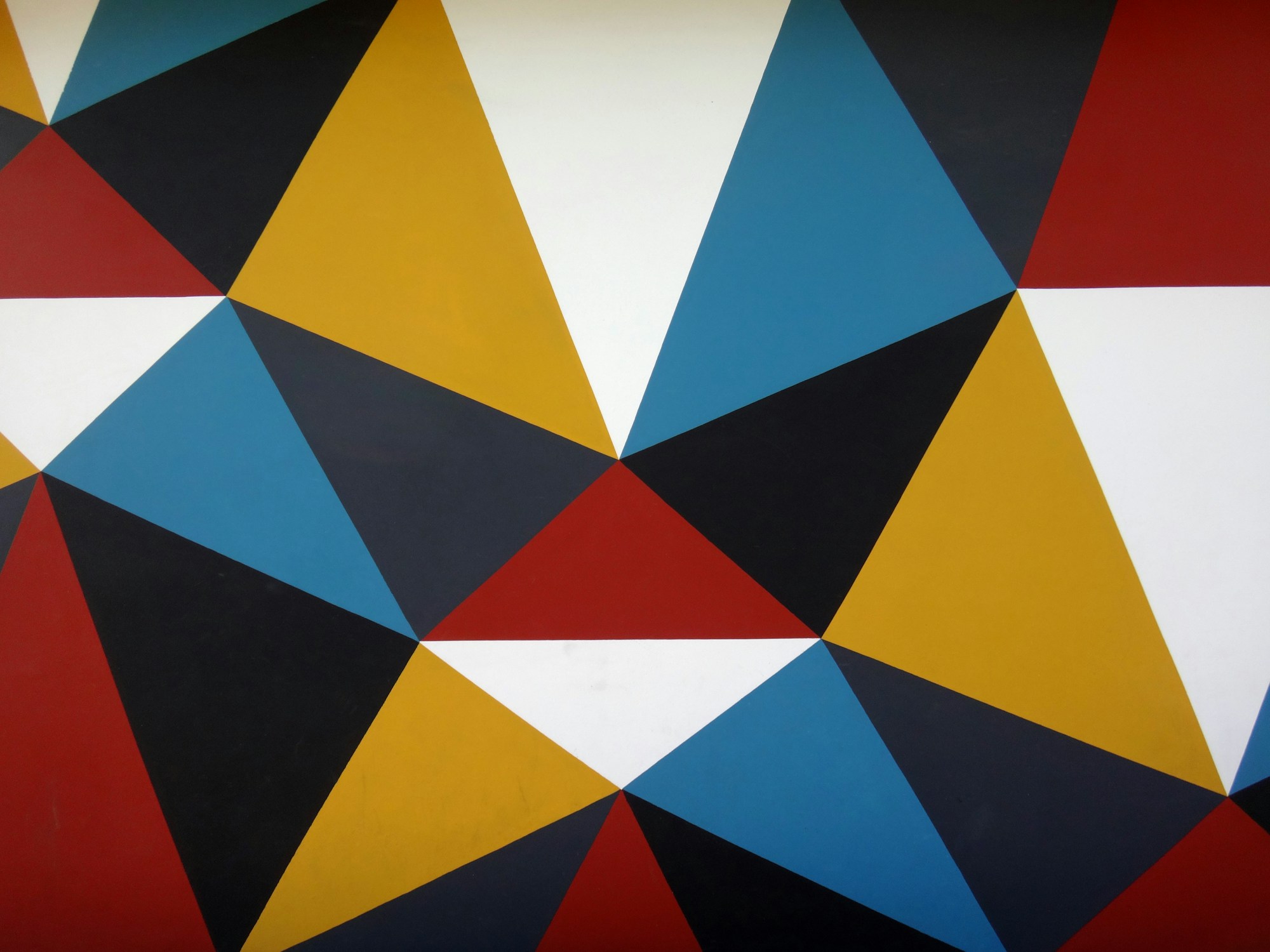 Easy canvas paintings: bold geometric triangle painting in red, blue, yellow and black