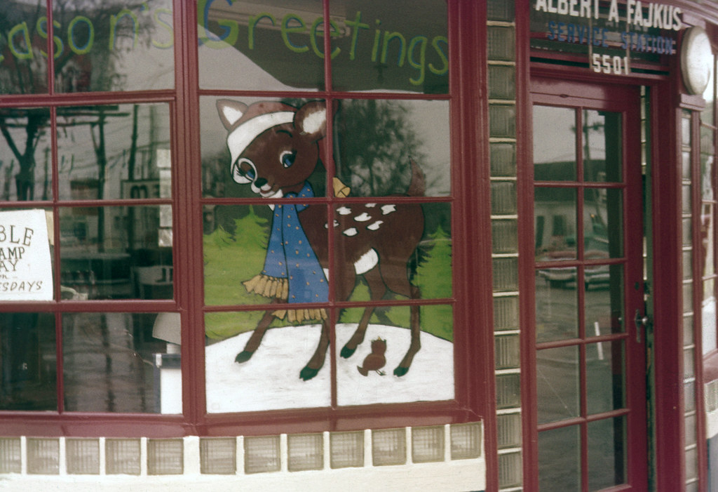 Christmas Window Painting of a little deer in a scarf on a vintage shop window