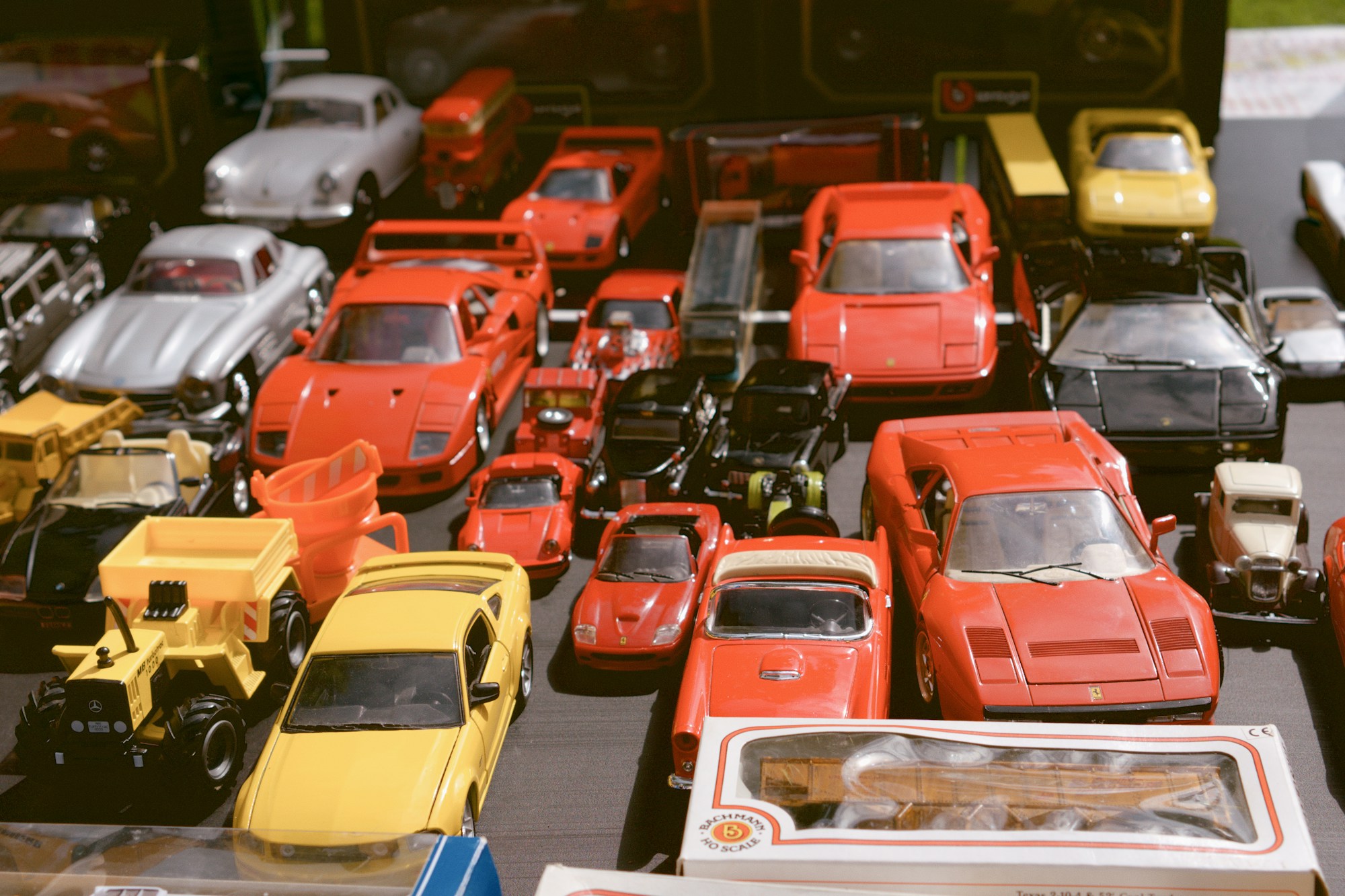 A collection of vintage toy cars on a display shelf