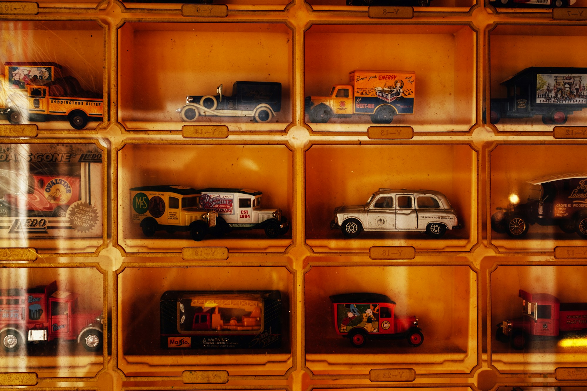 Vintage toy cars displayed in wooden cubbies