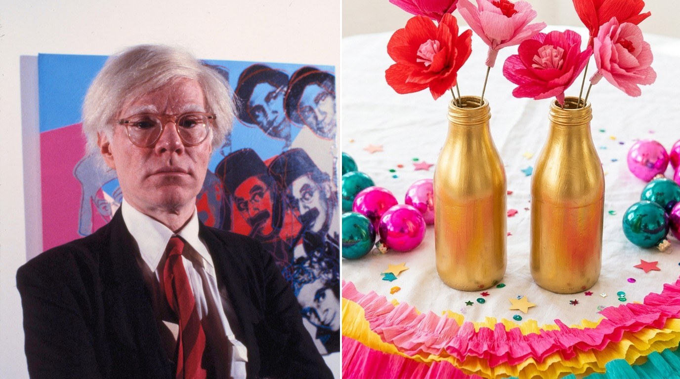 Andy Warhol Christmas party table with gold painted bottles, red and pink paper flowers, hot pink and teal ornaments and a crepe paper garland