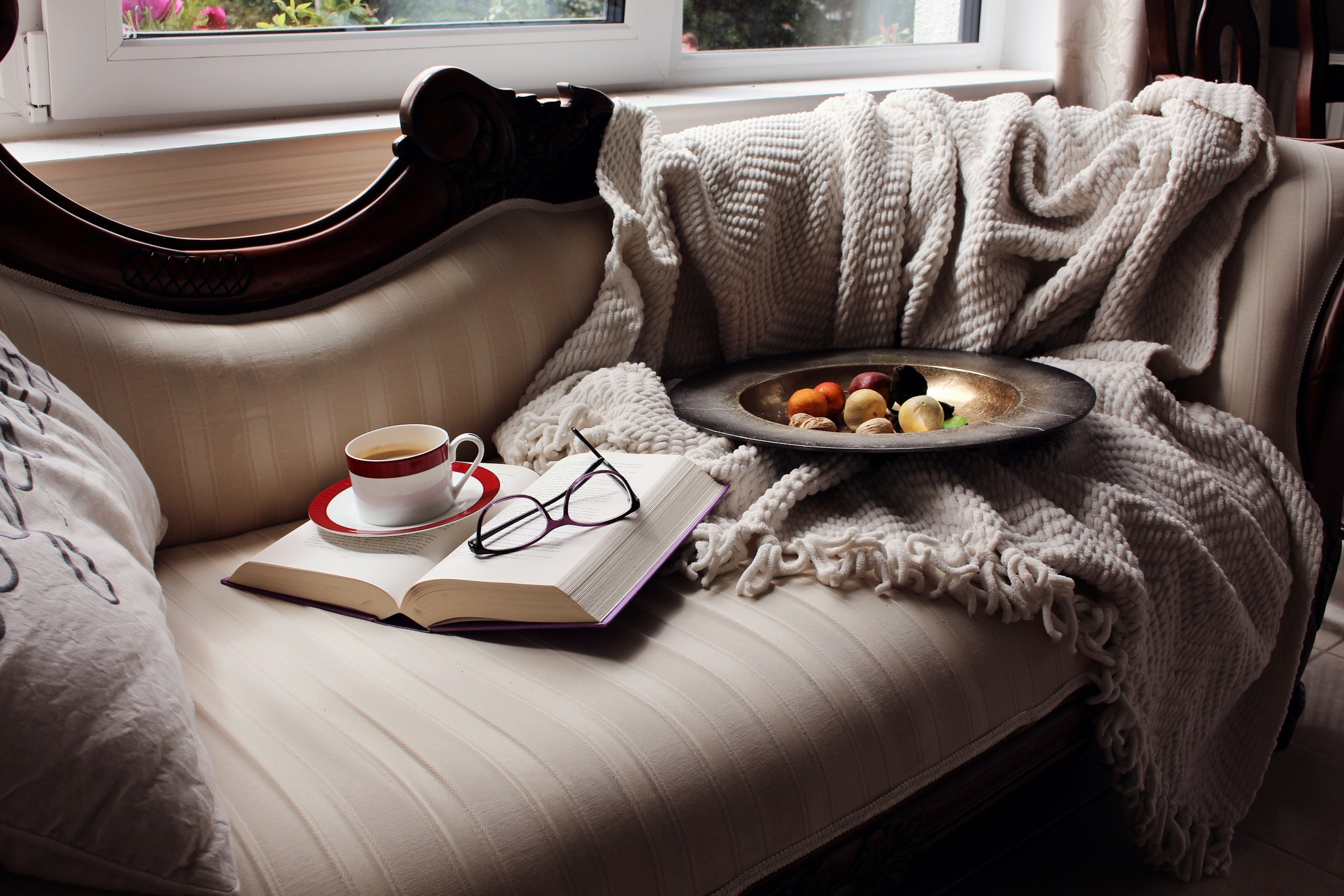 Cozy chaise lounge with a book, coffee and snacks