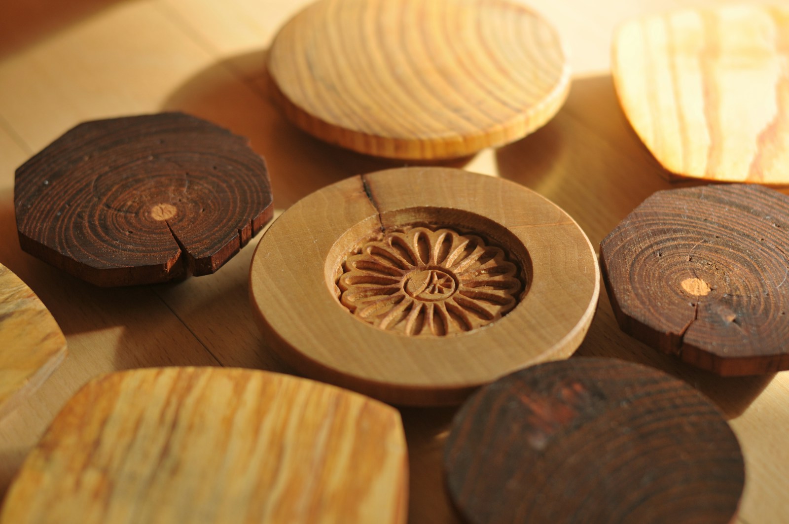 Natural tree slices with bark edges and carved centers on a table