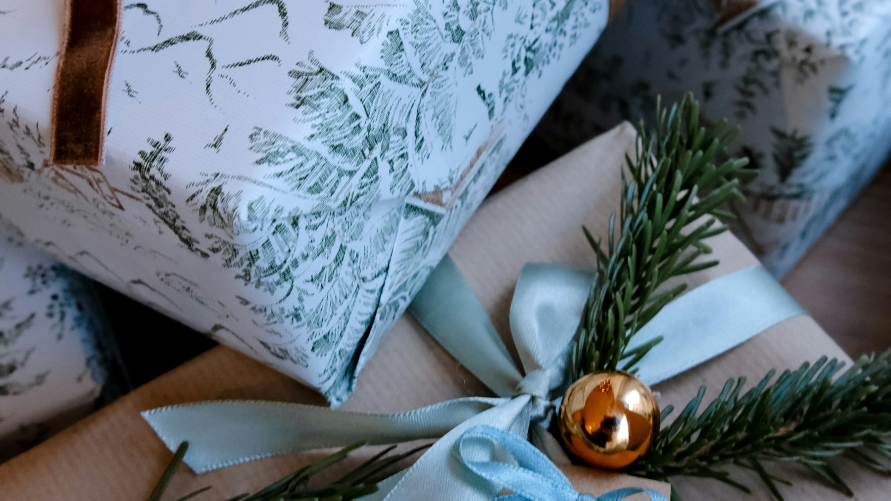 Wrapped gifts with handmade paper name tags and ribbons