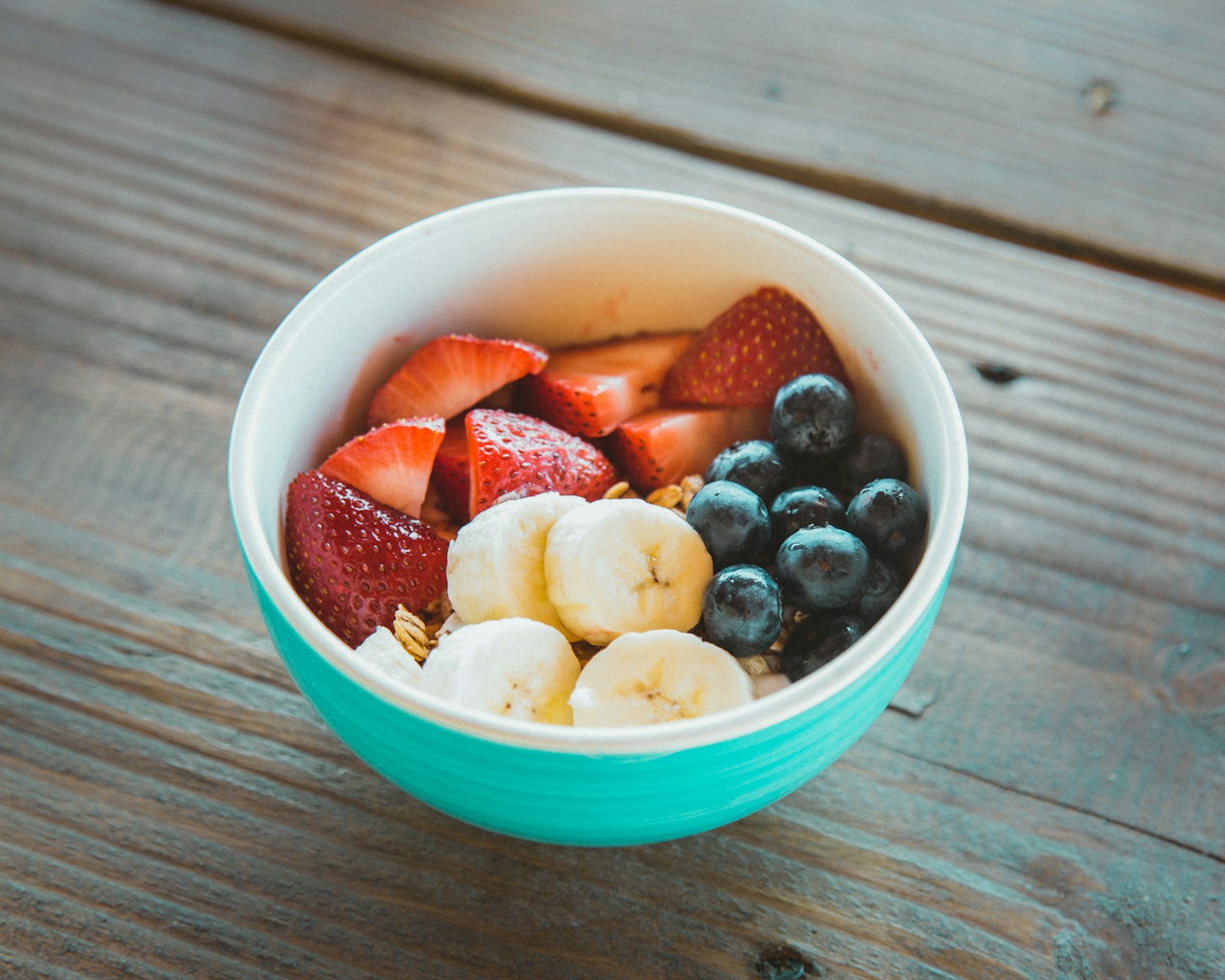 Oatmeal bowl topped with fresh fruit, one of the best pre workout snacks