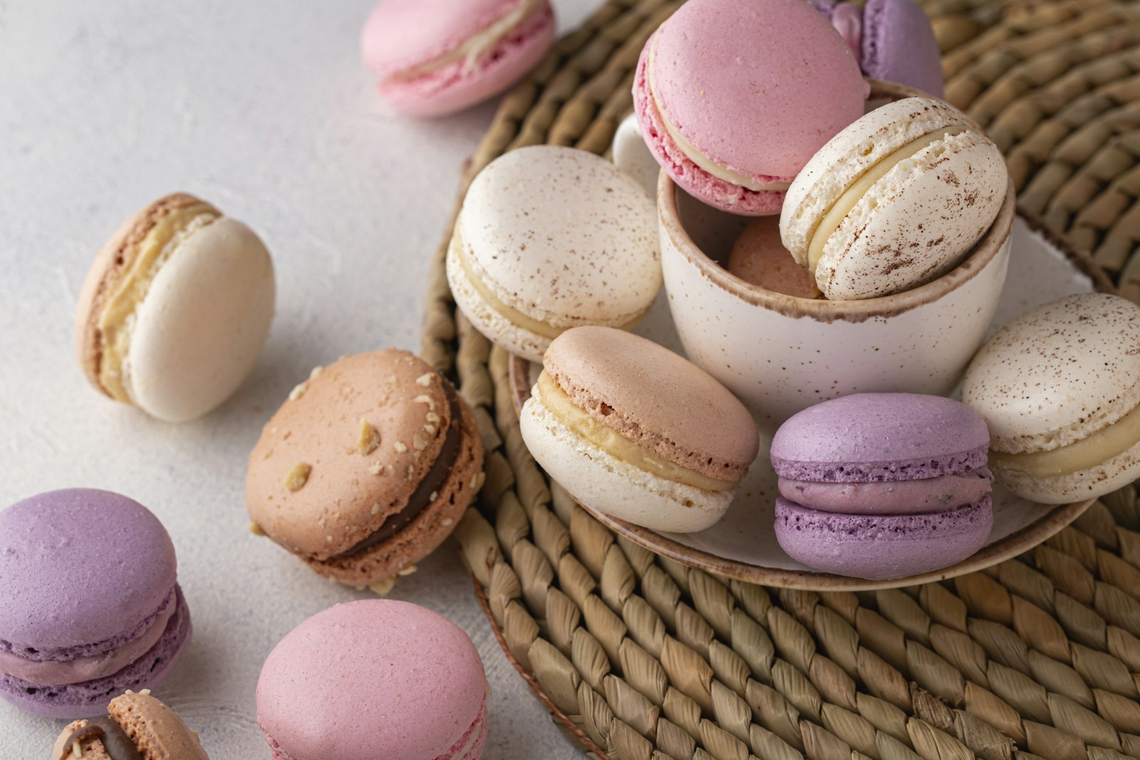 Pastel macarons in a wicker basket and cup