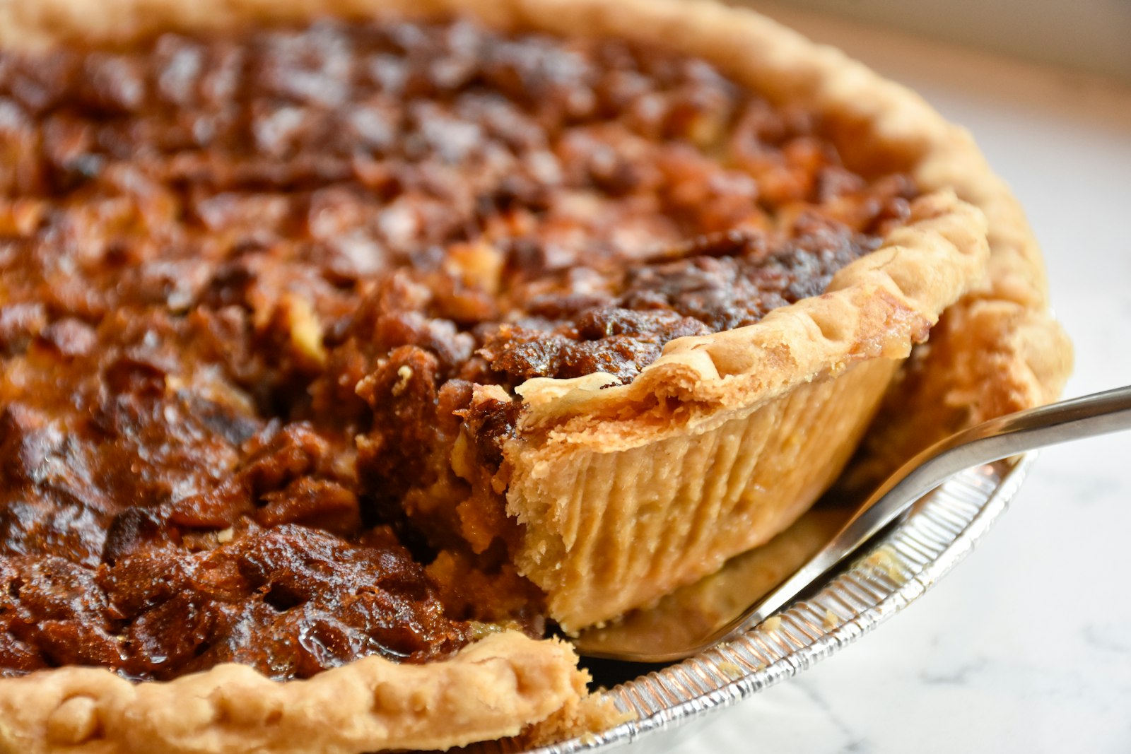 Homemade pecan pie with a slice cut