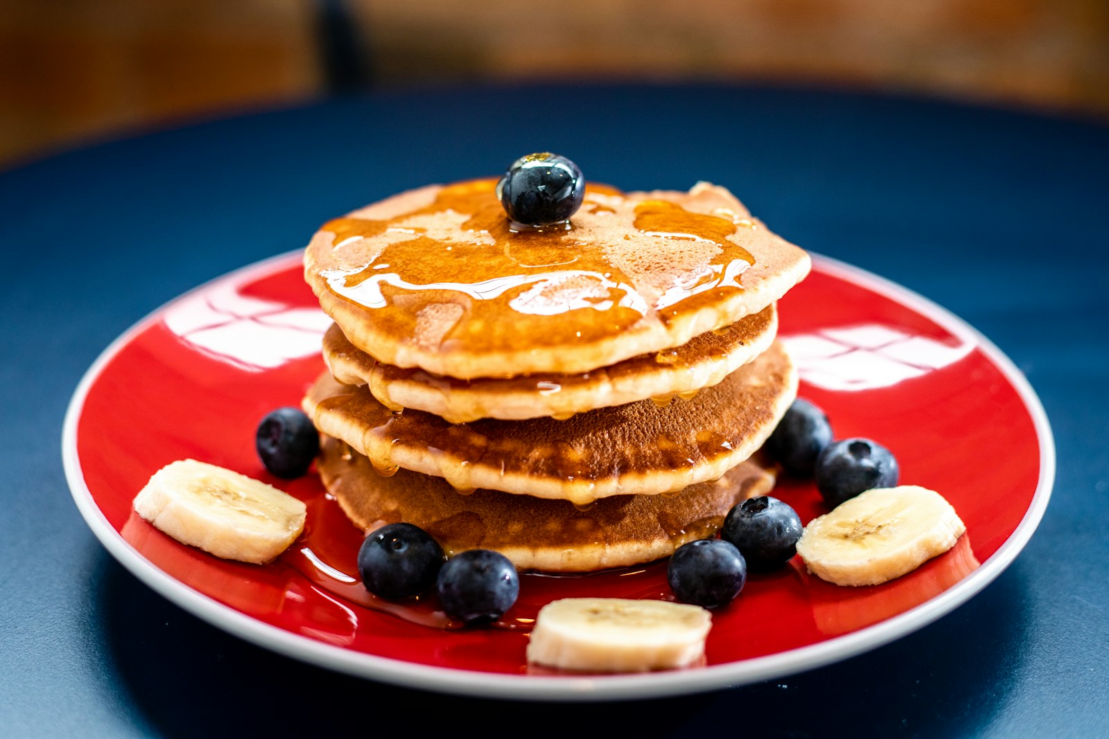 Stack of protein pancakes with berries and banana