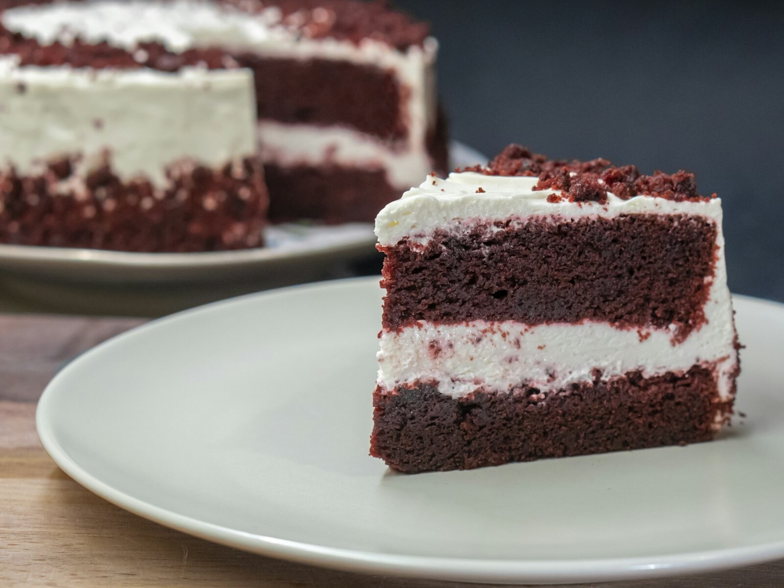 Slice of red velvet cake with cream cheese frosting