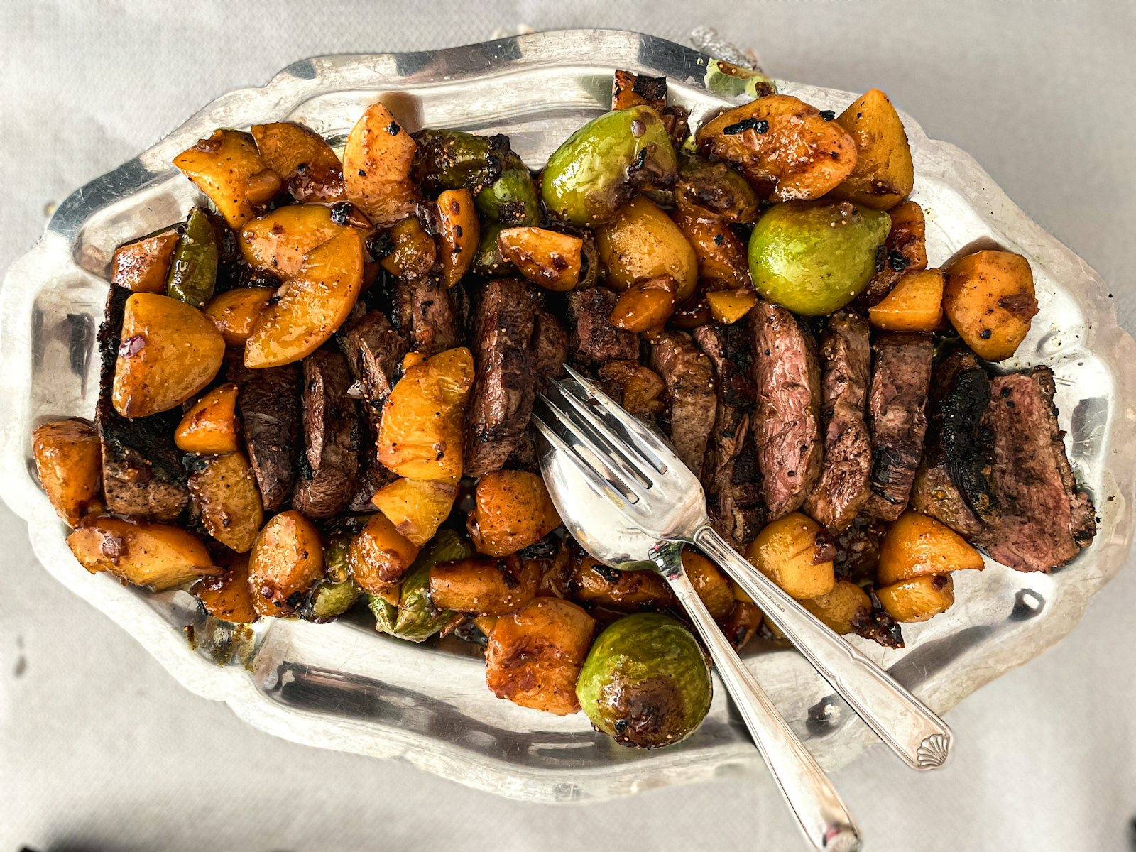 Steak bites and potatoes in a skillet