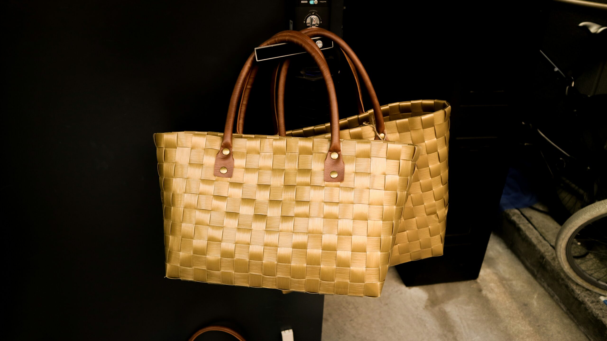 Two natural woven tote bags with brown handles, showing inspiration for a small placemat bag.