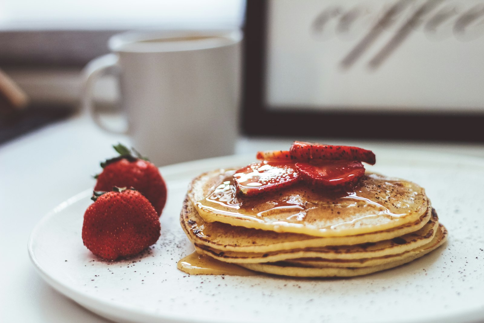 Pancakes with strawberries and syrup