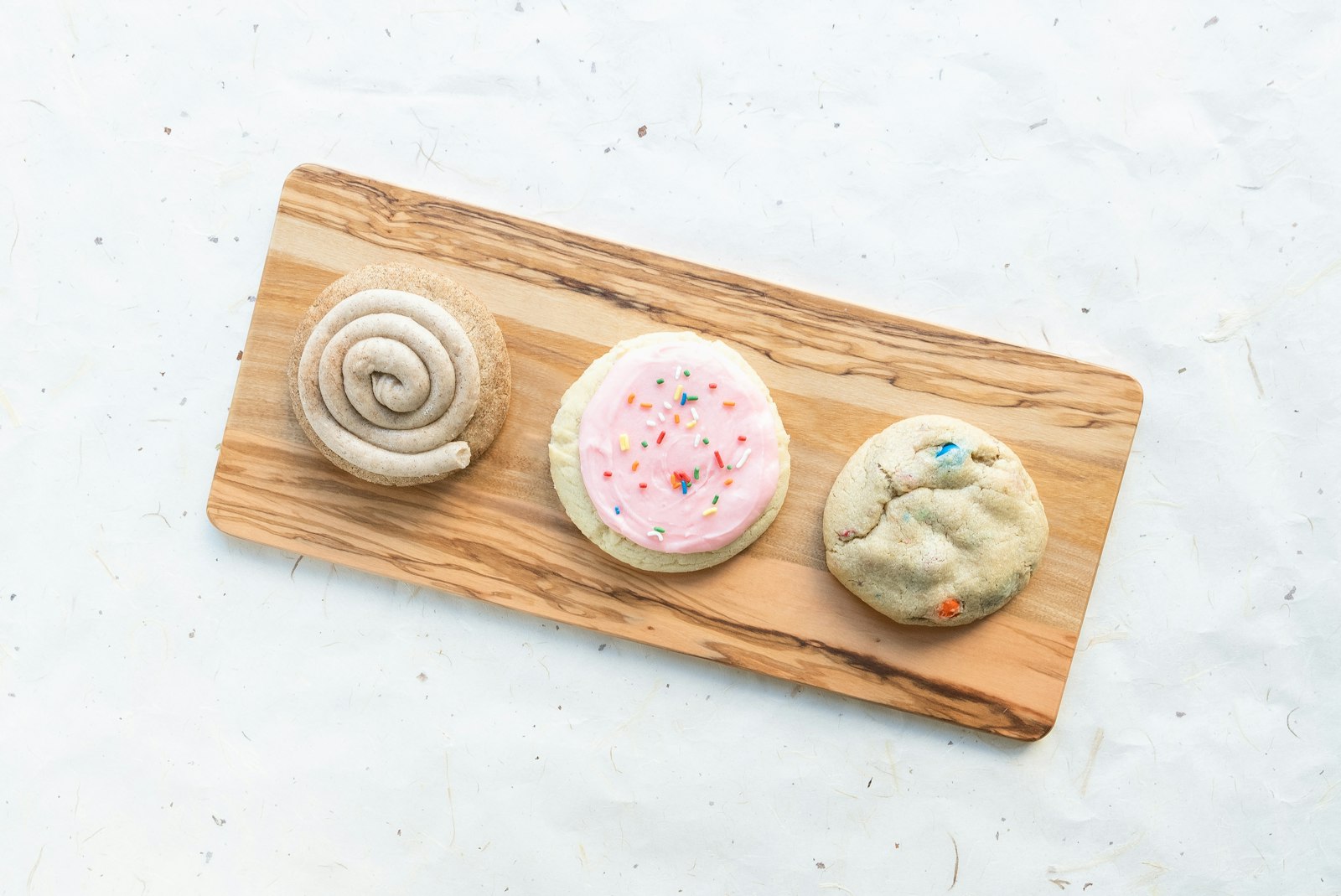 Frosted sugar cookies on a board