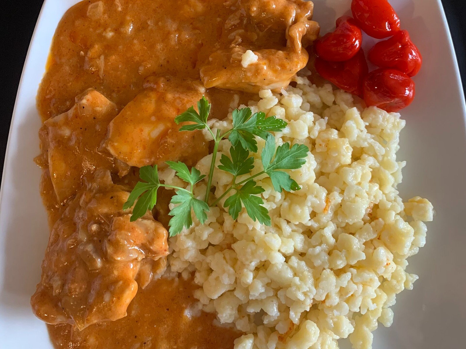 Hungarian paprikash in red paprika sauce with little dumplings