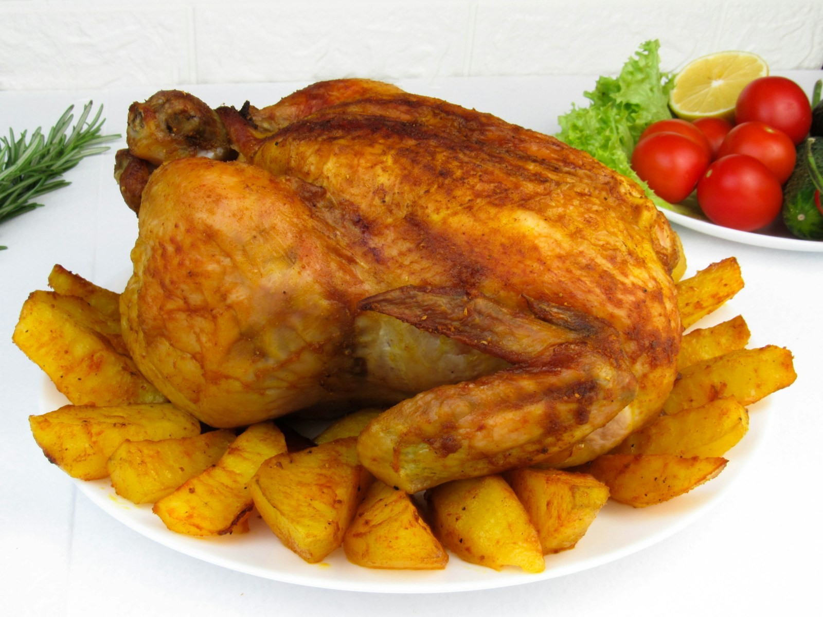 Whole roast bird on a bed of golden wedges