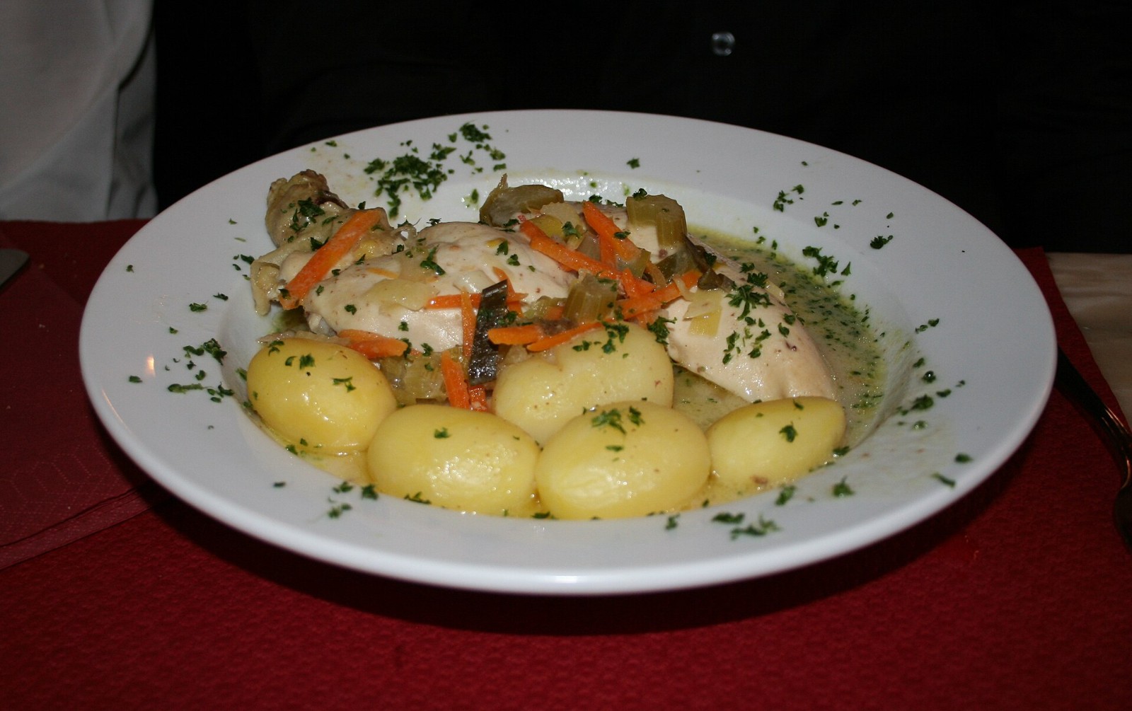 Belgian waterzooi stew with boiled potatoes and parsley