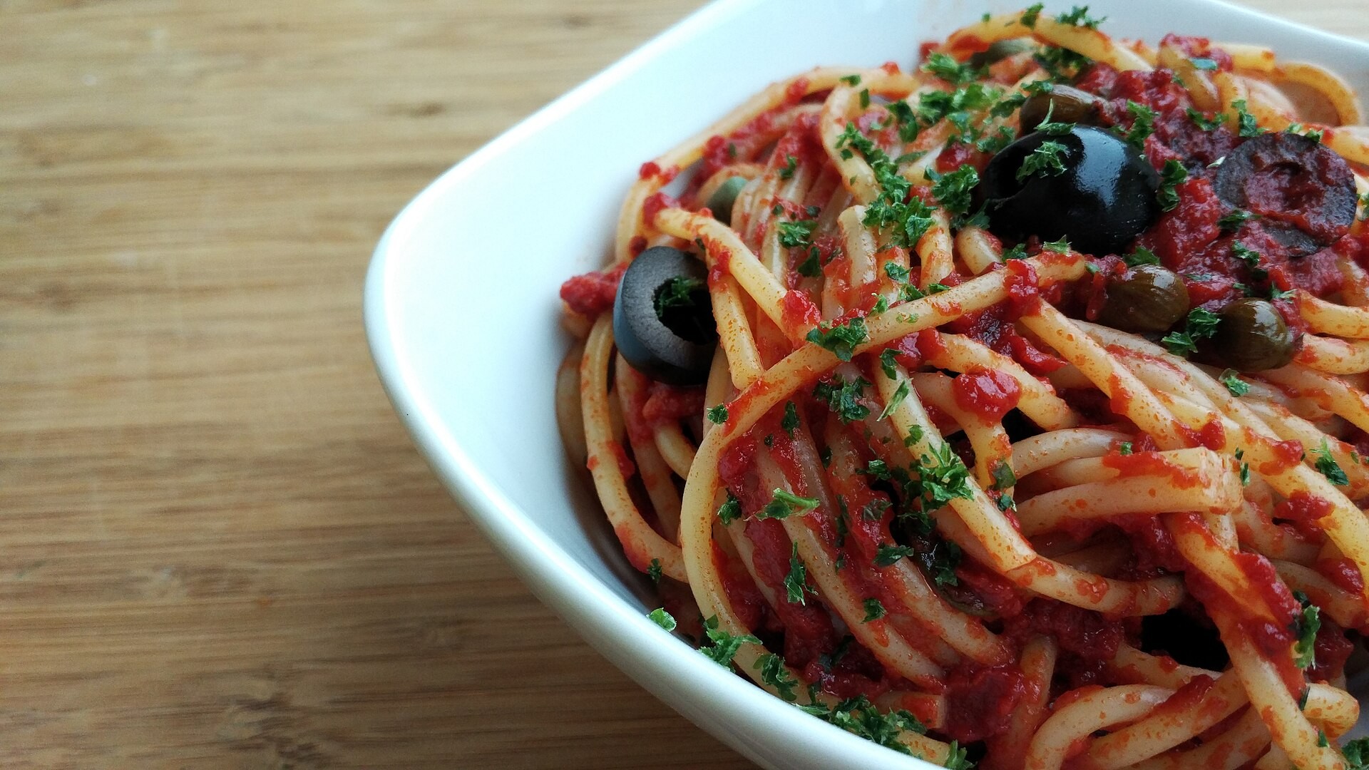 Spaghetti puttanesca with olives and anchovy tomato sauce