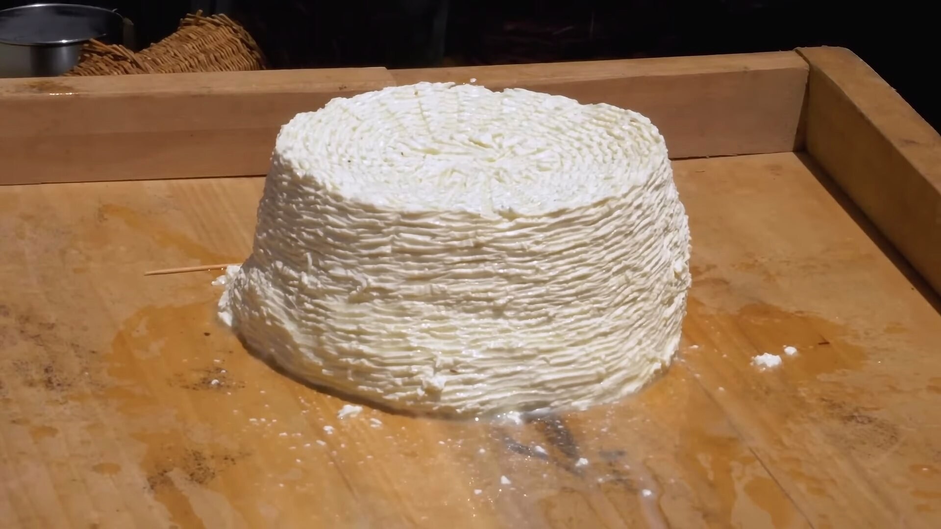 Fresh ricotta cheese on a wooden board