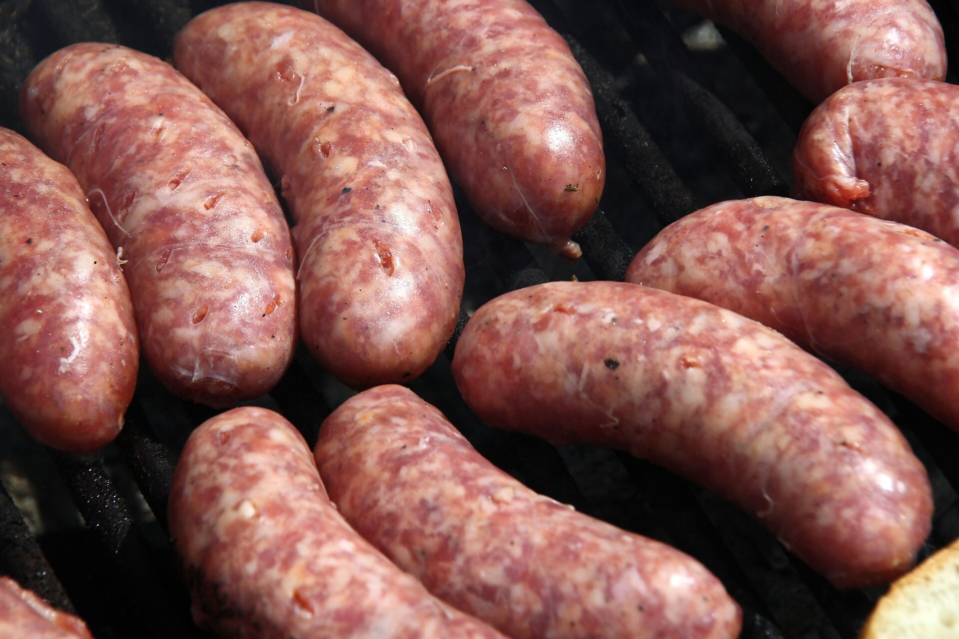 Fresh Italian pork sausages on a grill