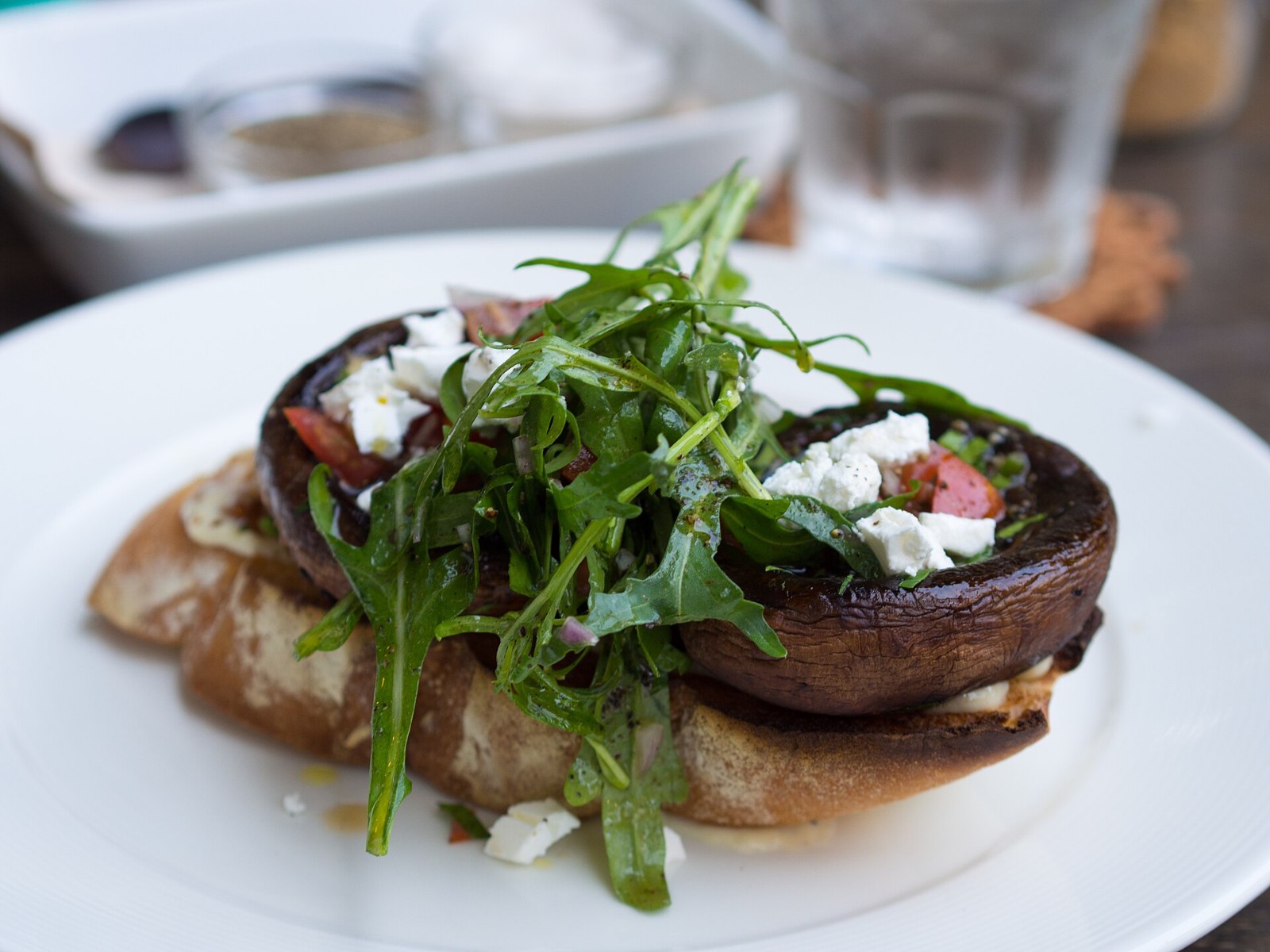 Roasted portobello with feta and arugula on toasted bread