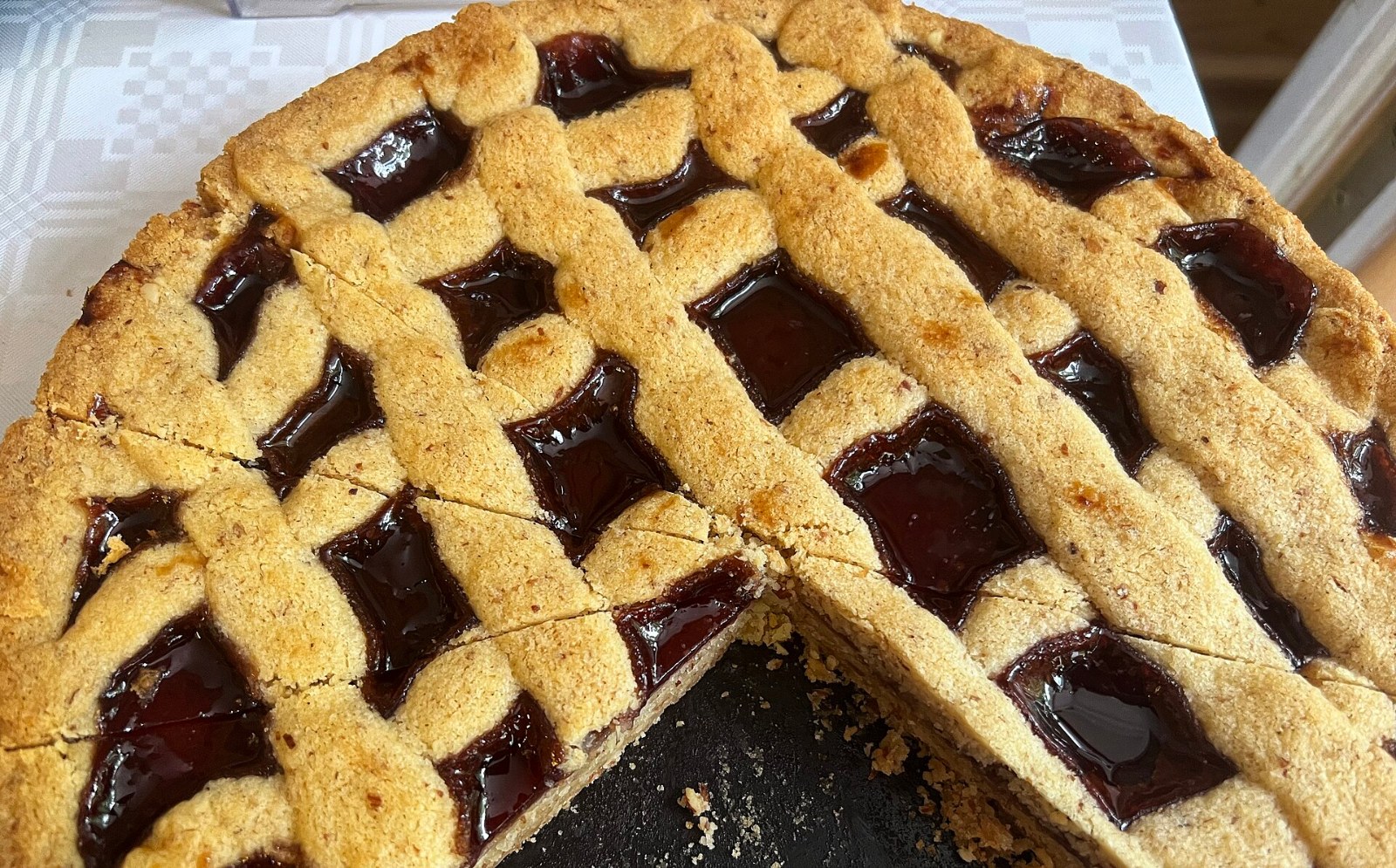 Linzer torte with raspberry jam filling under a golden lattice crust