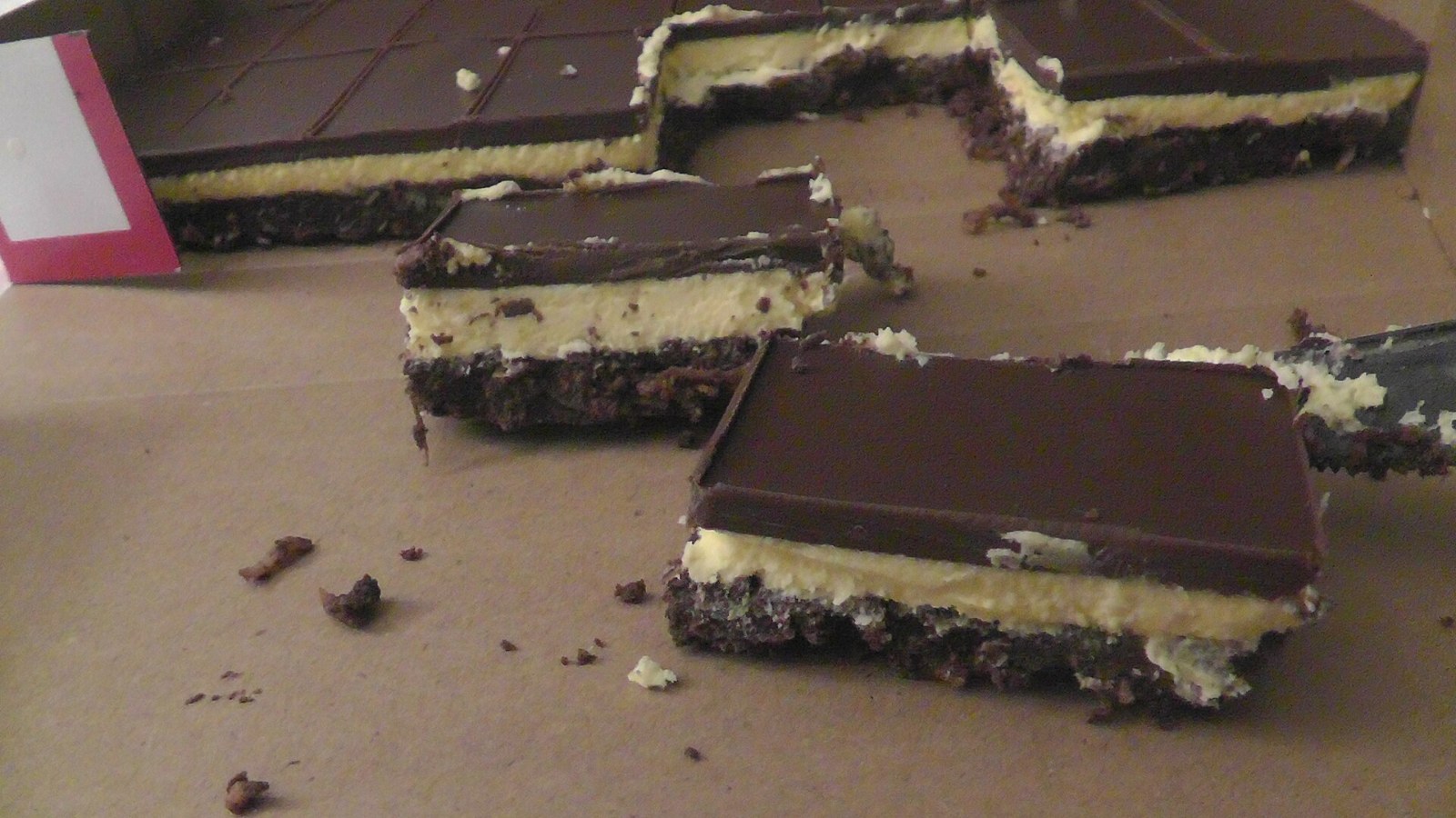 Nanaimo bars with a chocolate coconut base, custard cream filling and chocolate top