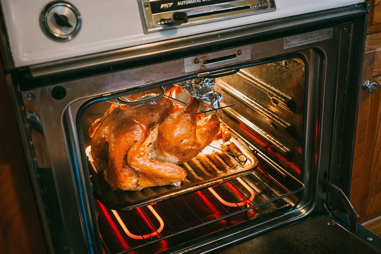 Alton Brown Thanksgiving style turkey roasting in a hot oven