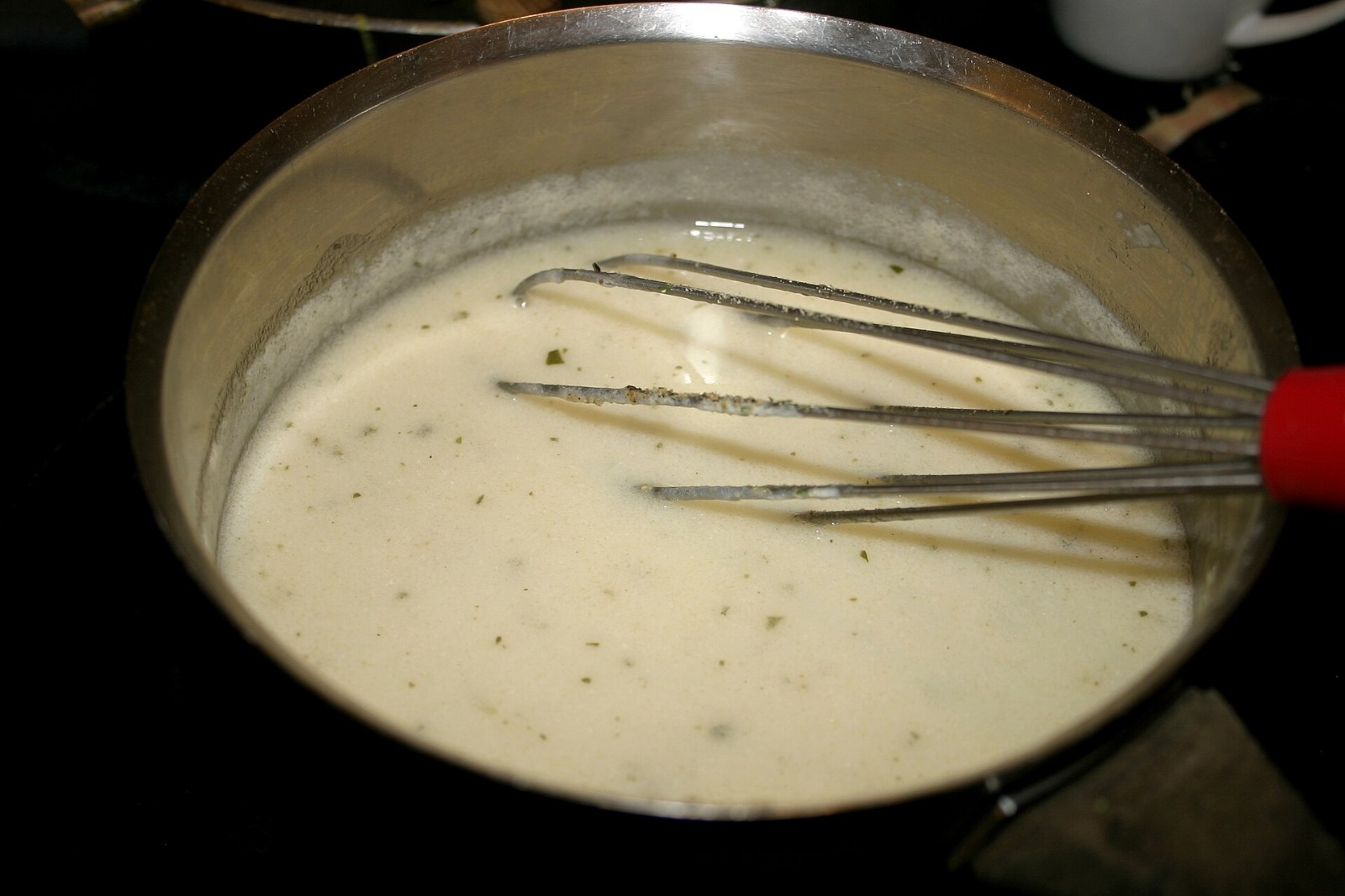 Whisk stirring smooth roux gravy for Thanksgiving in a saucepan