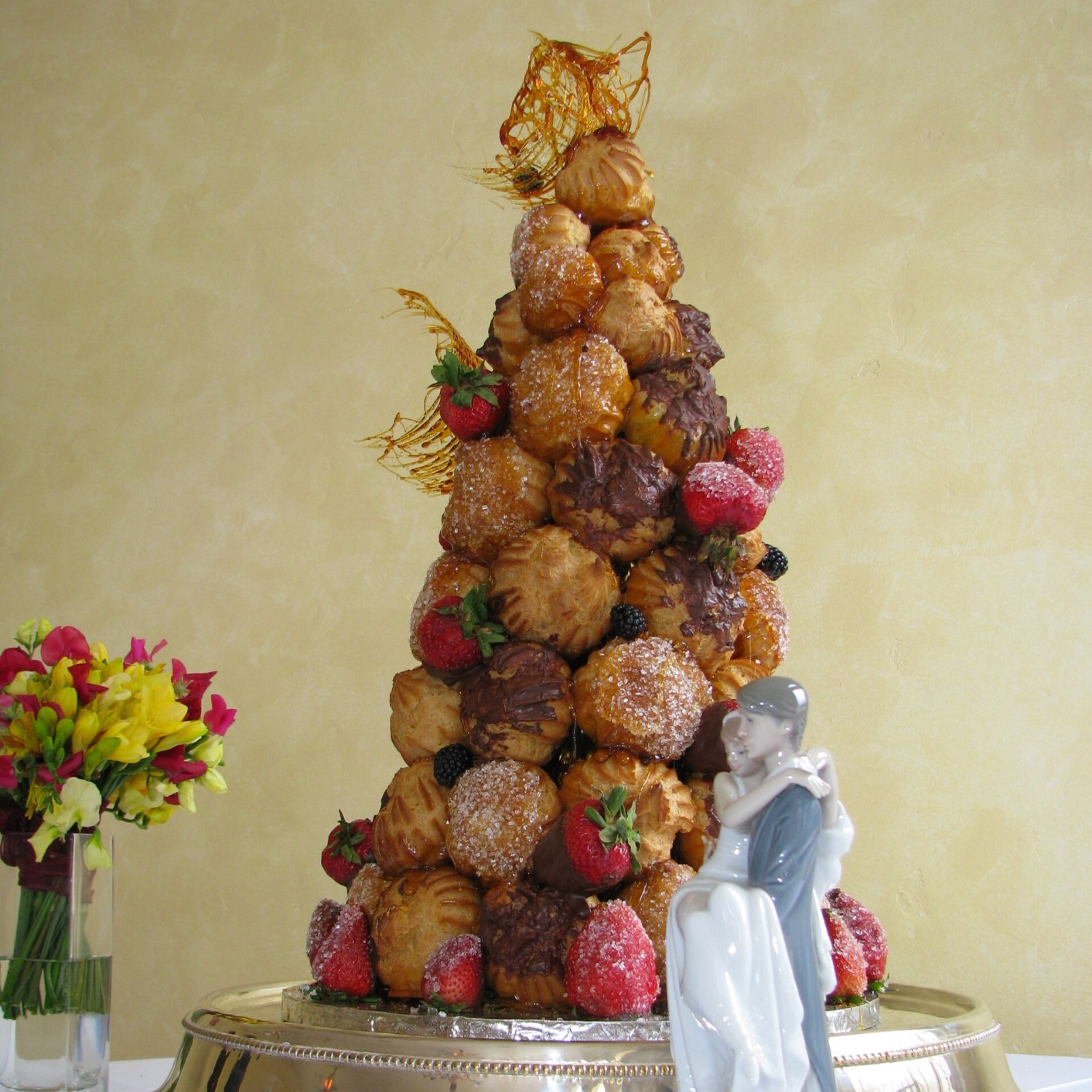 Tall croquembouche tower of cream puffs with caramel