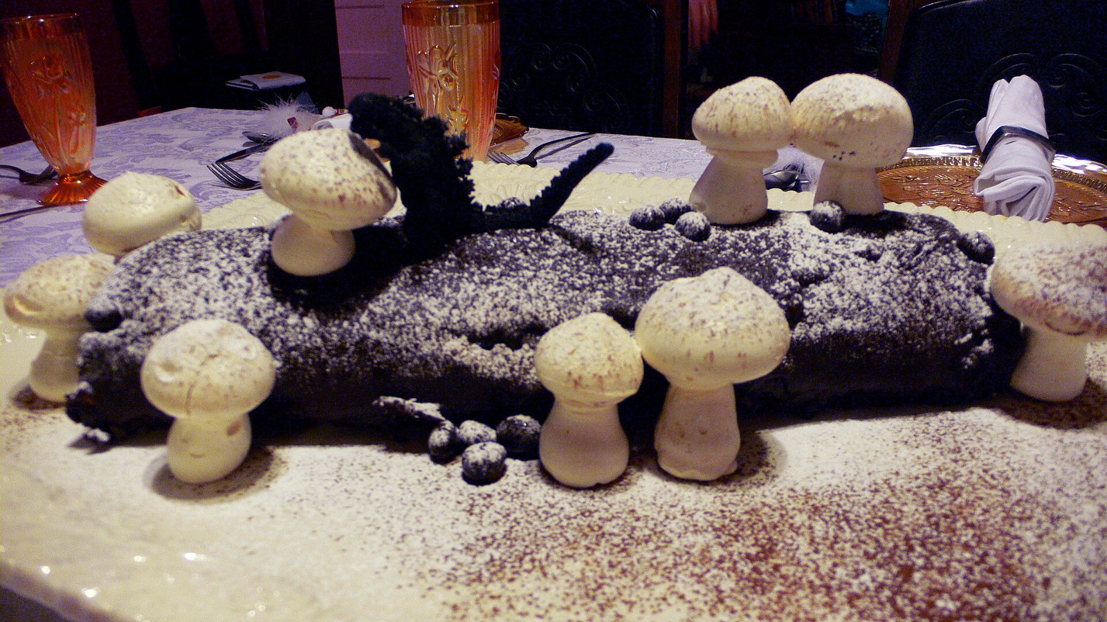 Chocolate yule log decorated with meringue mushrooms