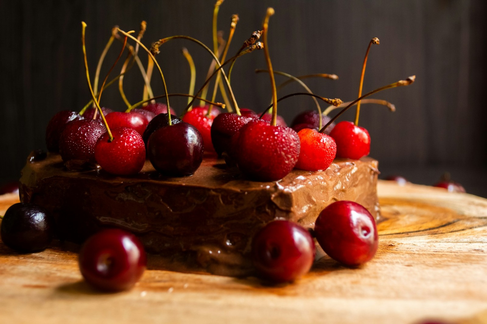 Chocolate fudge brownie slab topped with fresh dark cherries