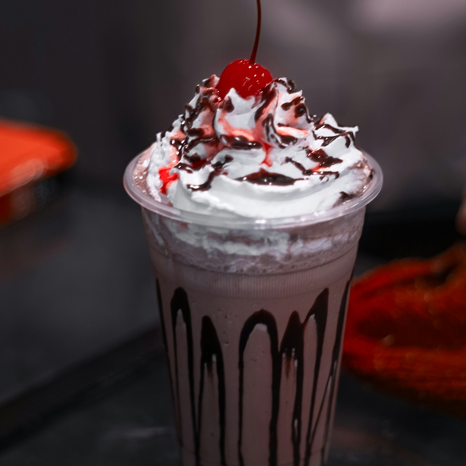 Black Forest milkshake with whipped cream, chocolate drizzle and a cherry on top